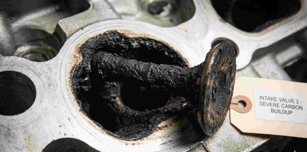 Close-up of severe carbon buildup on intake valves, a common Chevy 2.7 turbo engine problem caused by direct injection.